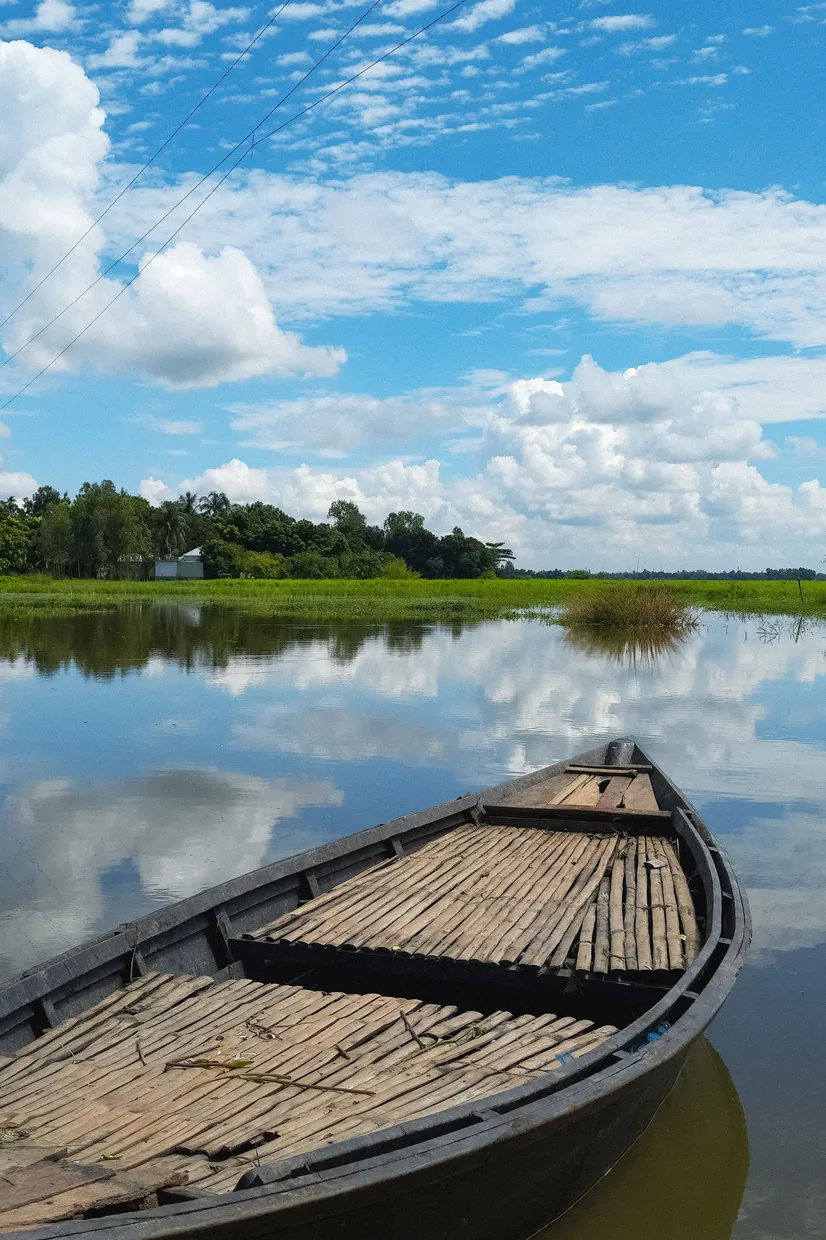 Wooden country boat moored on the water near Majuli, the river island reached by ferry from Jorhat